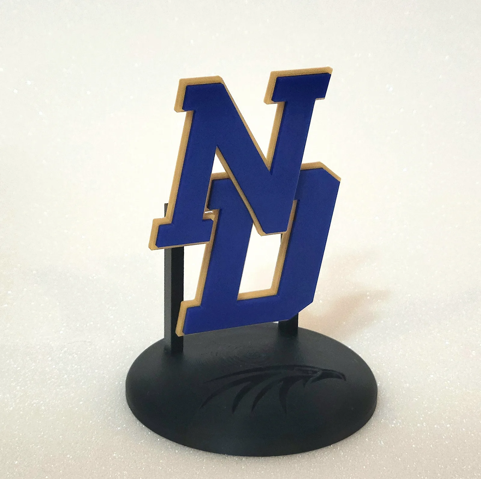 NU varsity-letter logo statuette with eagle base